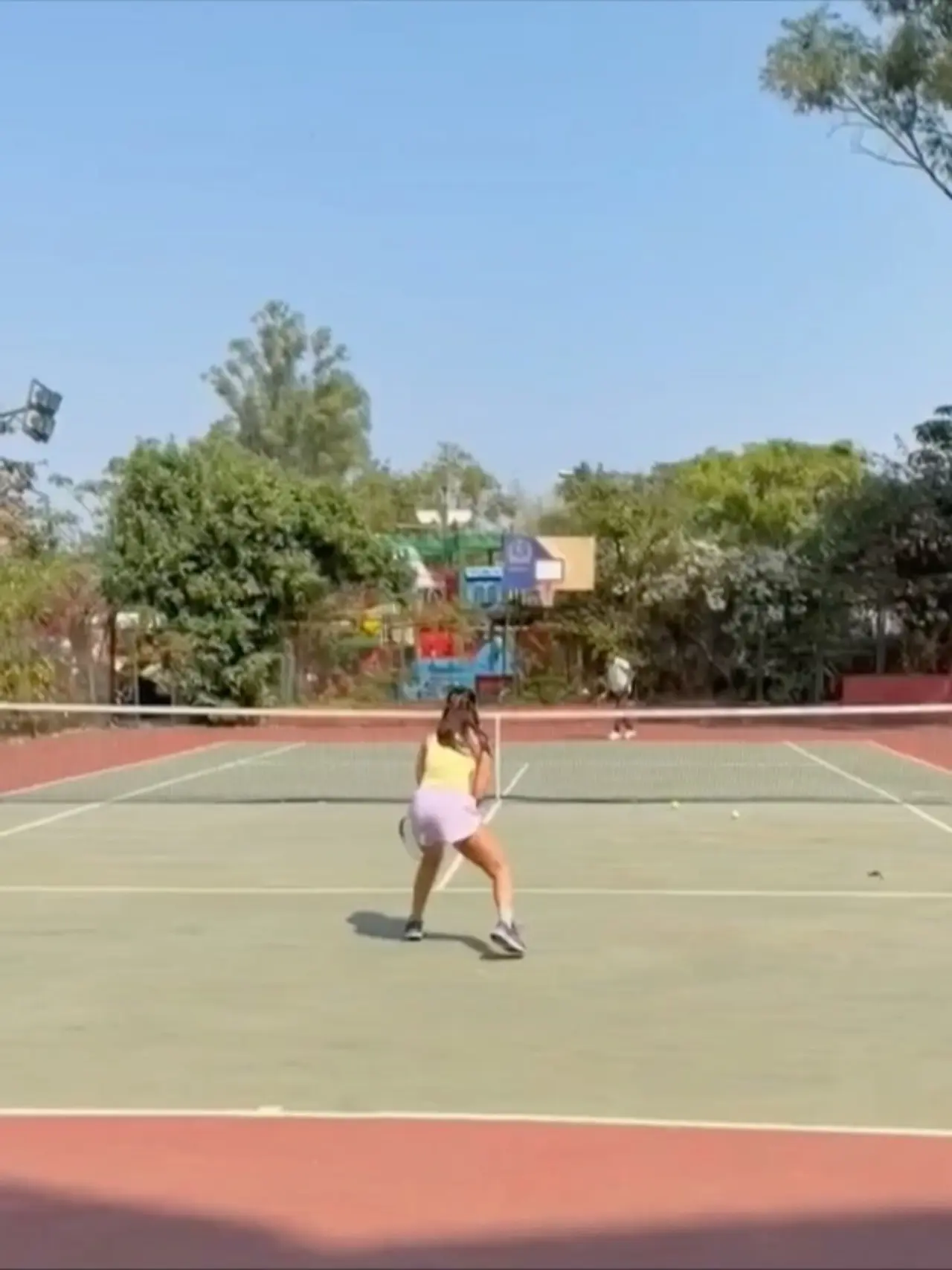 Alia Bhatt is seen enjoying a game of pickleball, dressed in a yellow top and white skirt. The actor keeps it sporty and stylish on the court.